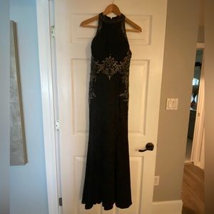 Black and silver Strapless neck Gown with bustled train.